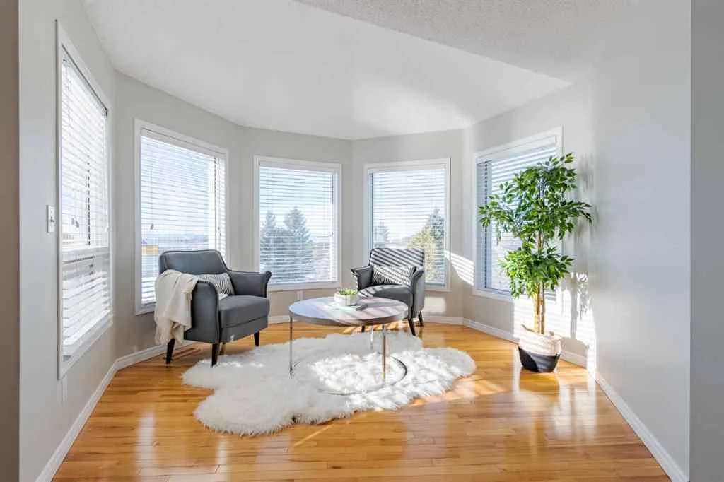 Bright sunroom in the same Calgary home with fresh neutral paint and crisp white window trim